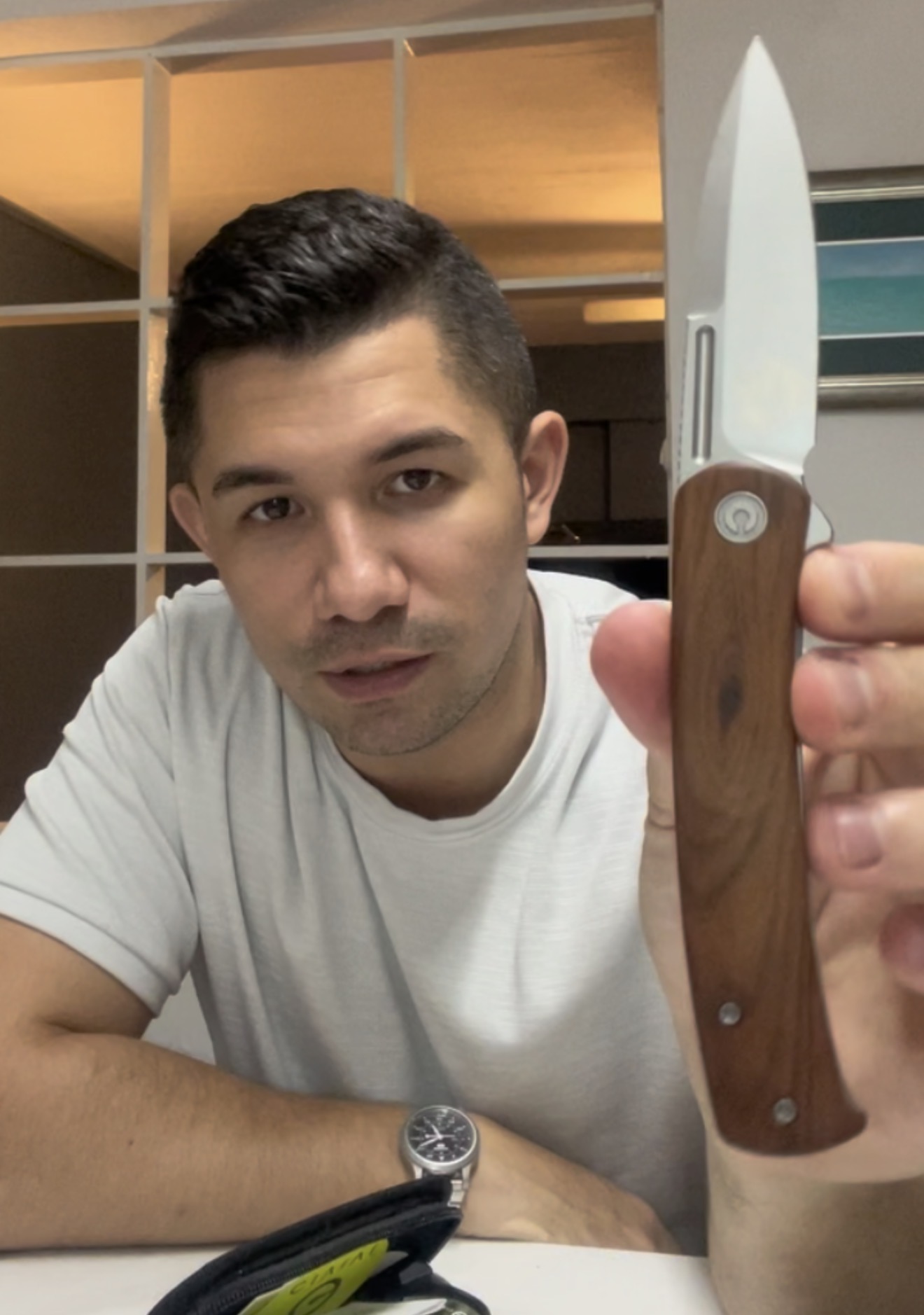 Zak Bermudez holding a freshly sharpened wood-handled knife