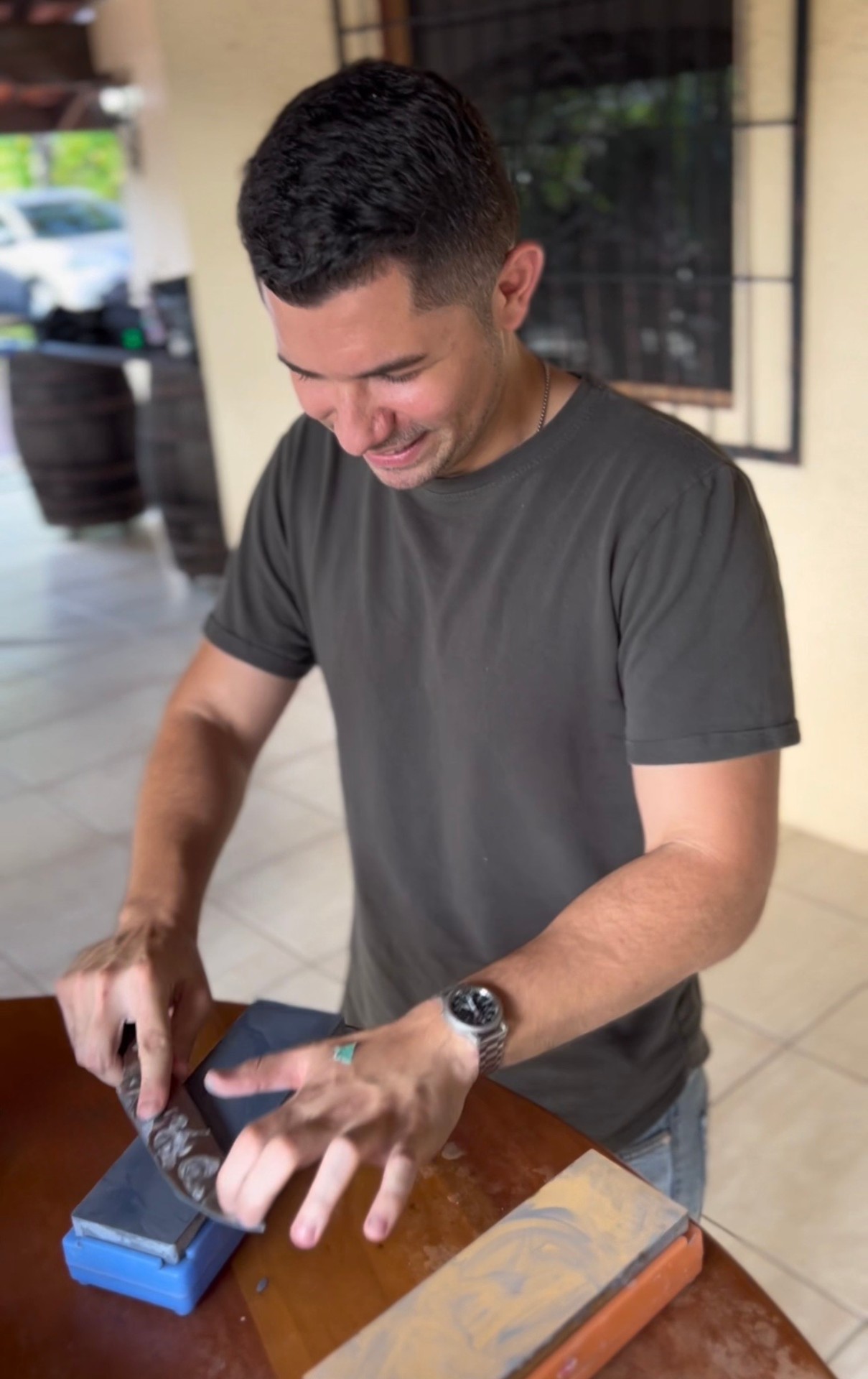 Zak Bermudez sharpening a knife on a whetstone